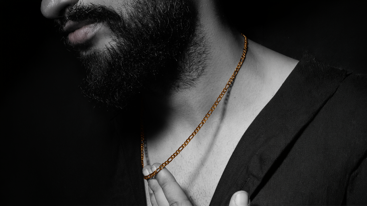 Chain for men — a gold plated cuban link chain and a silver-tone steel boa chain worn together