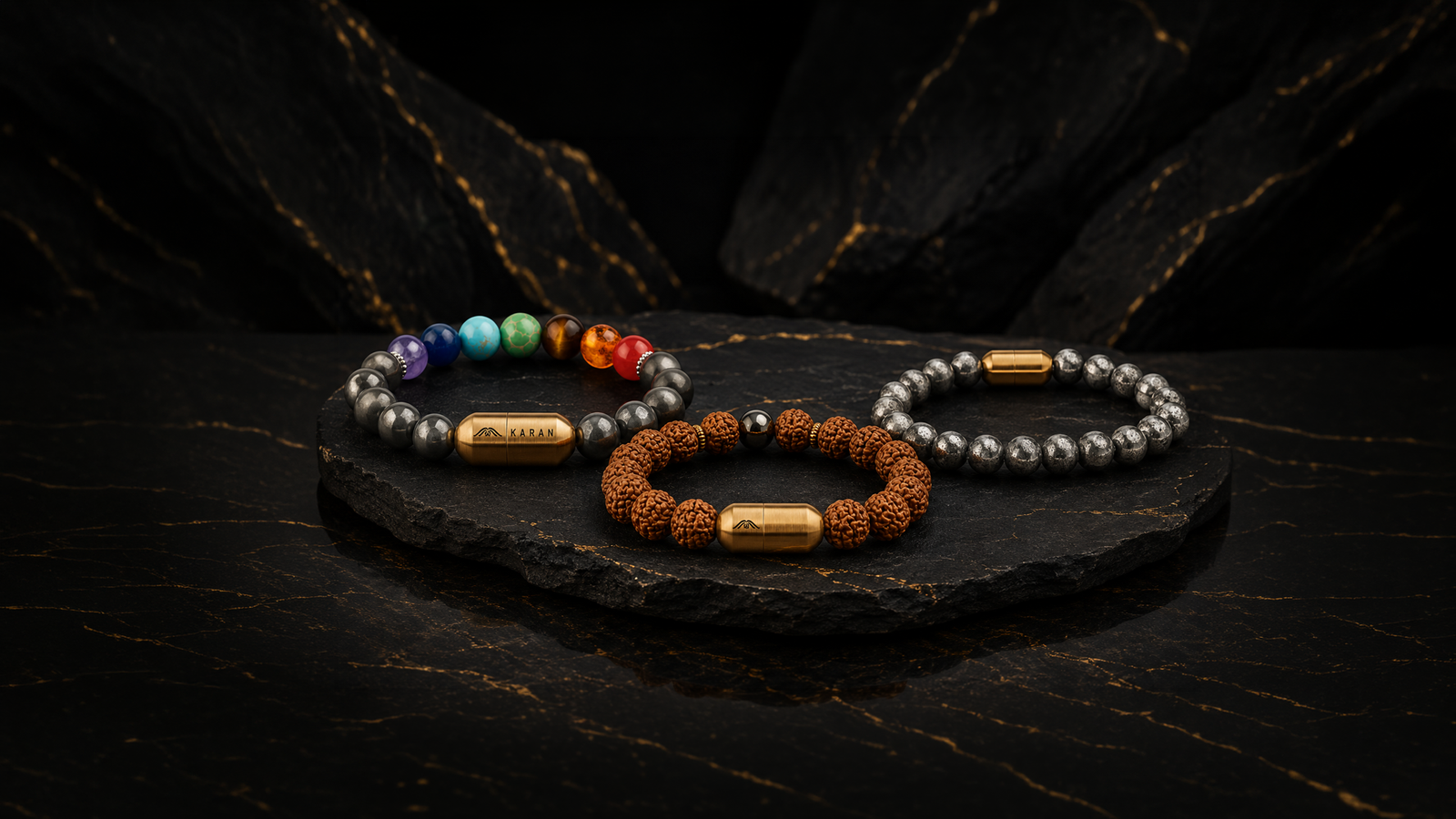 Crystal bracelet — tiger eye, amethyst and rudraksha bead bracelets stacked on a wrist with engraved steel spacers