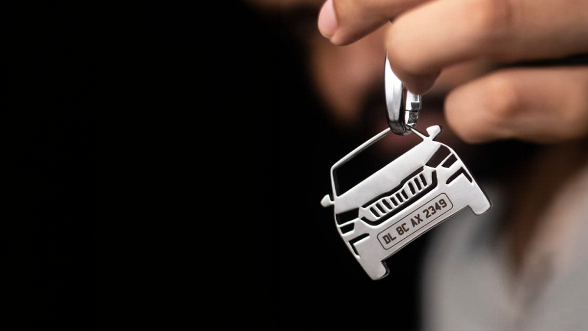 Car keychain — engraved stainless steel number plate key ring hanging from a set of car keys